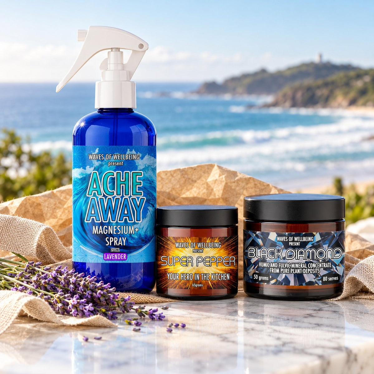 The Byron Bay Collection gift set: Ache Away Lavender magnesium body spray, Super Pepper and Black Diamond on marble overlooking Byron Bay