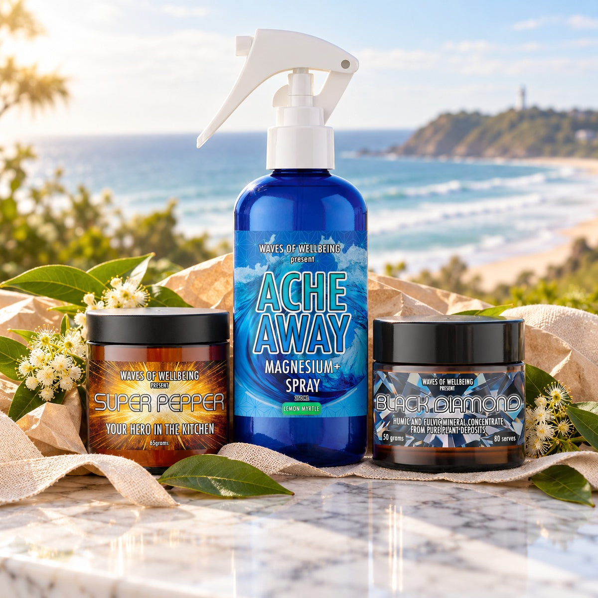 The Byron Bay Collection gift set: Ache Away Lemon Myrtle magnesium body spray, Super Pepper and Black Diamond on marble overlooking Byron Bay