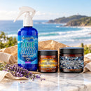 The Byron Bay Collection gift set: Ache Away Lavender magnesium body spray, Super Pepper and Black Diamond on marble overlooking Byron Bay