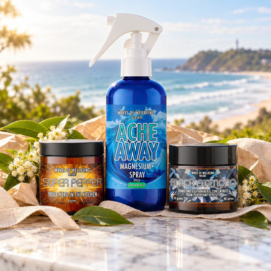 The Byron Bay Collection gift set: Ache Away Lemon Myrtle magnesium body spray, Super Pepper and Black Diamond on marble overlooking Byron Bay