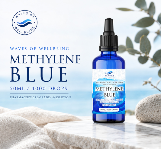 Waves of Wellbeing Methylene Blue 1% solution 50ml, 1000 drops, cobalt glass dropper bottle on marble with eucalyptus and a coastal background