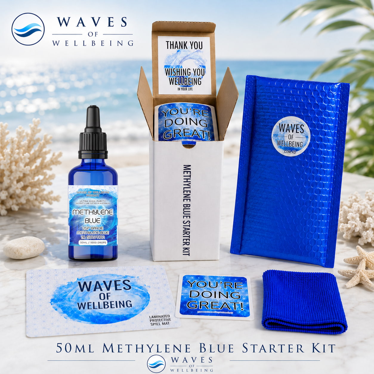 Waves of Wellbeing 50ml Methylene Blue Starter Kit — bottle, bubble mailer, spill mat, microfibre cloth and welcome cards on marble with coastal background