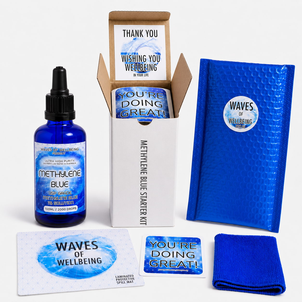 Waves of Wellbeing Methylene Blue Starter Kit unboxed — 100ml bottle, bubble mailer, spill mat, microfibre cloth and welcome cards